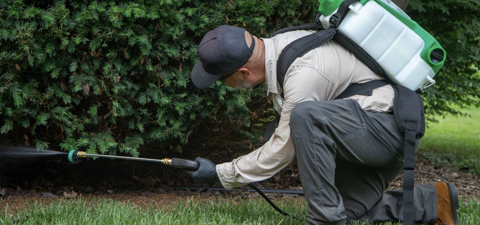 An Evo technician treating the perimeter of a home