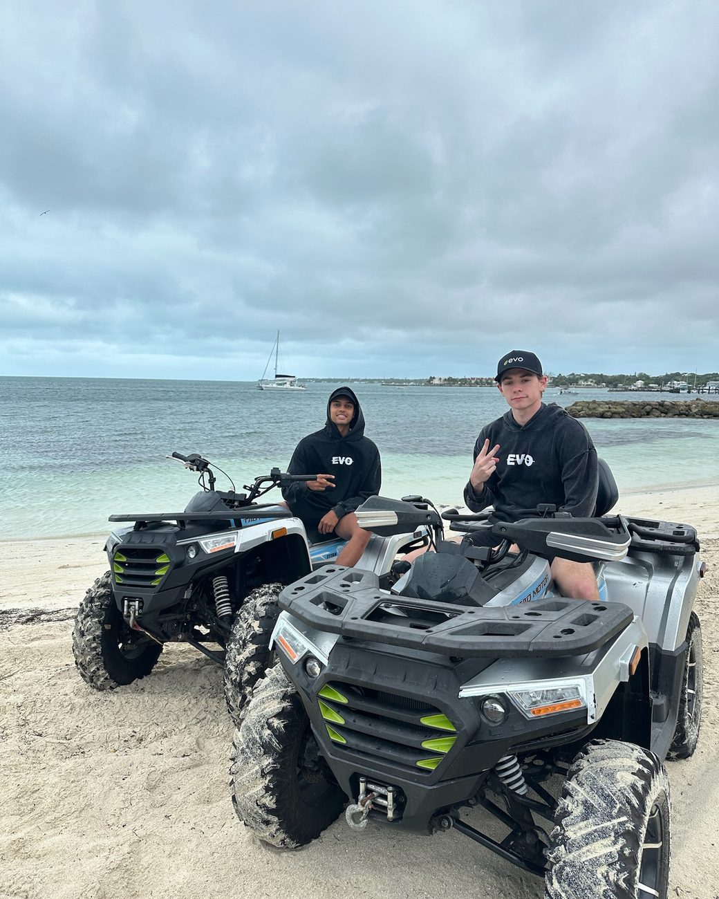 Evo reps riding ATVs on the beach on a team trip
